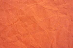 Full frame shot of crumple orange colour paper sheet texture and background. photo