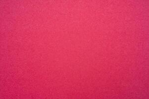 Full frame shot of recycled red paper sheet texture and background. Colored paper or construction paper, is a type of paper that comes in a wide range of colors. photo