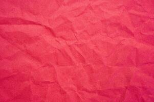 Full frame shot of crumple red paper sheet texture and background. photo