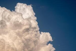 Cumulonimbus clouds appear on the clear sky. photo