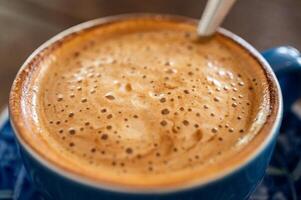 Close up of the surface of hot latte coffee. photo