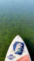 A paddle board in the water with a bag on it video