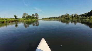 A kayak on the water with trees in the background video