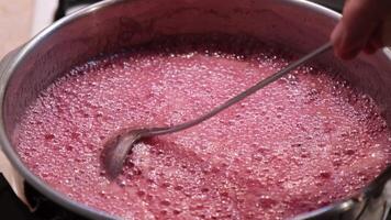 Mixing jam in the pot when boiling in four time slow motion video
