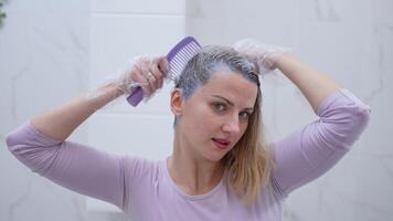 Transforming hair color with a bold shade in a cozy bathroom video