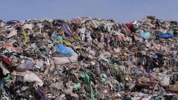 A massive accumulation of debris and plastic waste illustrates the pressing environmental issues caused by inadequate waste management practices video