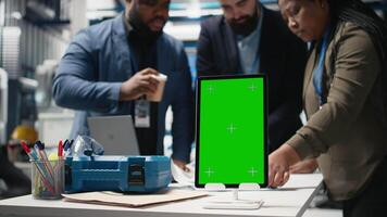 Team of consultants and experts working with a chroma key screen in the solar panel facility, ensuring manufacturing process efficiency with clean energy and solar technology. Camera B. video