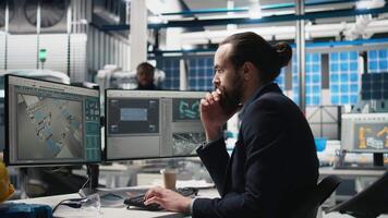Professional consultant reviewing solar power quality in a factory, reviewing data reports and insight for seamless production line and sustainable solar energy. Photovoltaics industry. Camera B. video
