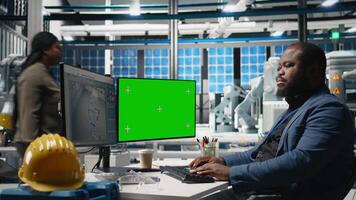 Solar power specialist works on manufacturing strategy next to mockup, combining industrial insight with renewable energy goals for sustainability and high tech development. Camera B. video
