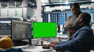 Team of african american consultants work with chroma key screen in the solar panel factory, ensuring detail alignment with renewable energy efficiency and solar power tech. Camera B. video