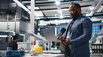 Executive manager overseeing green energy production in a high tech plant, ensuring sustainability and innovation in solar panels manufacturing or infrastructure planning. Camera B. video