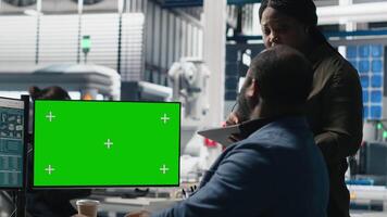 Team of african american consultants work with chroma key screen in the solar panel factory, ensuring detail alignment with renewable energy efficiency and solar power tech. Camera A. video
