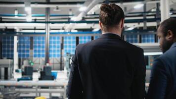 Team of inspectors consultants reviewing the solar power plant activity and production line, ensuring the correct manufacturing process. Master engineers examine factory equipment. Camera A. video