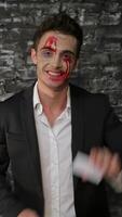 Playful vampire man showcases his business card with a charming grin video