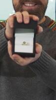 Joyful mature man presenting a dazzling engagement ring in an elegant gift box video