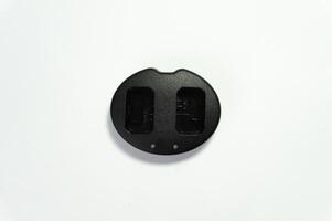 Closeup of black camera charger isolated on white background photo