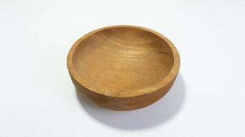 Close-up View of an Empty Wooden Bowl on a White Background Surface photo