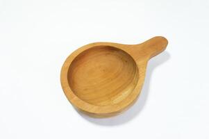 Close-up of empty wooden bowl with handle against white background representing natural and rustic kitchenware photo