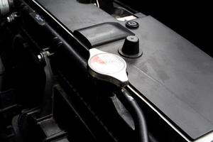 Radiator Cap, A close-up of a radiator cap on a car radiator in the vehicle cooling system. photo