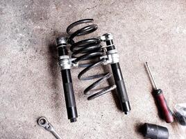 Coil spring compressor or Spring compressor, A tool for pressing springs to remove them from car shock absorbers or struts. photo