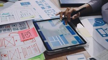 A person is working on a tablet with a bunch of design documents video