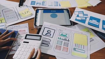 A table with many papers and a calculator video