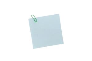 Post It Note or Sticky Note, A single green paperclip secures a blank light blue square note, isolated on a white background include clipping path photo