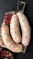 Raw meat sausages made from beef or pork, fresh meat for barbecuing or grilling. Sausages as a background for your design video