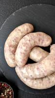 Raw sausages made from beef or pork, fresh meat for grilling. Raw sausages as a background for your design video