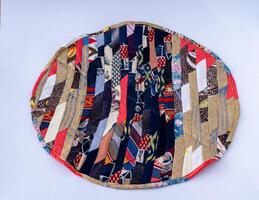 Patchwork. A fragment of multi-colored pieces of fabric sewn together. Round colorful rug photo