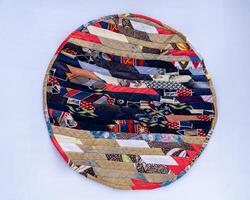 Patchwork. A fragment of multi-colored pieces of fabric sewn together. Round rug photo