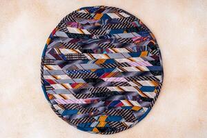 Patchwork rug. A fragment of colorful pieces of fabric sewn together. photo
