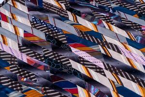 Patchwork. A fragment of multi-colored pieces of fabric sewn together. Colorful Quilted Patchwork Fabric Blanket photo