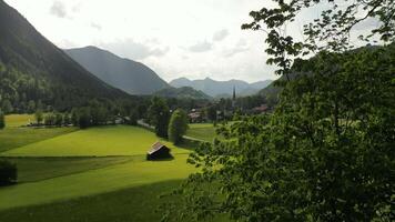 A green field with a small village in the distance video