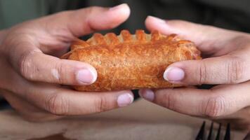 Enjoying a freshly baked pastry in a cozy setting video