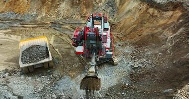 Excavator loading dump truck in quarry mining operation. Stock clip video