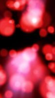 Abstract red bokeh background with soft round glowing light circles against a black backdrop video