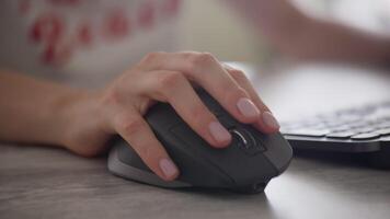 Close-up of Hand Using Computer Mouse with Keyboard in Background video