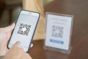 QR code payment, woman hands or customer using smartphone for paying at shop. photo