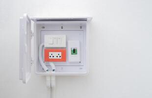Set of old electrical, socket switch installed at white wall outside home with copy space. photo