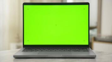 Laptop with chroma key green screen in a modern home setting video