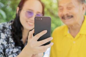 Happy father and daughter with smile and laugh while sharing something funny in a mobile phone. photo