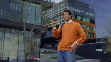 Smiling young man on call in city video