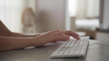 Hands Typing on White Keyboard in Modern Workspace video
