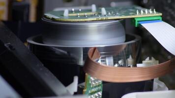 Vhs helical head gyrating reading and stopping and ejecting a videotape video