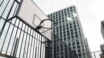 Playing on a sports field in an urban landscape, the basketball team loses because the basketball does not hit the hoop. video