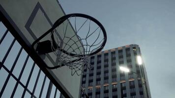 The basketball will accurately hit the hoop when playing streetball in the city. team earns a point. Close up. video