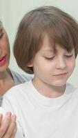 Joyful mother and son exploring vibrant shampoo options at the drugstore video