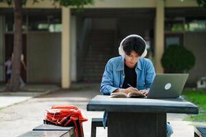 Man sitting and writing note lecture while prepare exam. photo