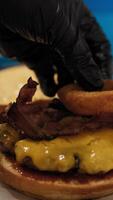 Chef Adding Onion Rings To Complete The Gourmet Burger Dish video